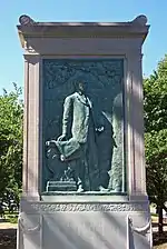 Bronze tablet on a stone structure depicting a standing man