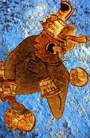 Mural arqueológico con figura de guerrero sobre fondo azul maya