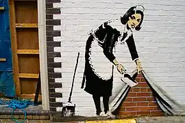 Sweep It Under The Carpet, uno de los grafitis de Banksy.