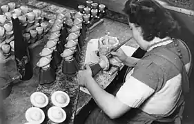 Artesano pintando a mano Räuchermänner en Seiffen (1947).