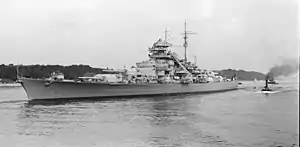 Black and white photograph of the port side of a Bismarck class battleship.