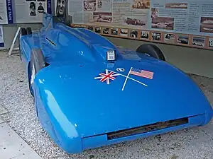 A front right view of a blue coloured racing car.