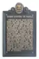 Placa informativa de la historia del centro.