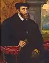 Carlos I de España, rey 1516, Emperador 1520, con gran coste y los interesados en América se rebelan, Comuneros y Germanías.  Guerras con Francia en Italia, tras el cisma el Imperio Alemán se desune hasta la Paz de Augsburgo, Enrique VIII de Inglaterra casado con Catalina de Aragón busca un hijo, al no tenerlo crea el Anglicanismo para divorciarse, se casa 6 veces, y mata 2. Lega reinos a Fernando y Felipe.