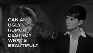 Still shot of a film trailer showing Shirley MacLaine looking down at the left and Audrey Hepburn to her right staring at her, in a bedroom. The words "Can an ugly rumor destroy what's beautiful?" obscure much of MacLaine's face