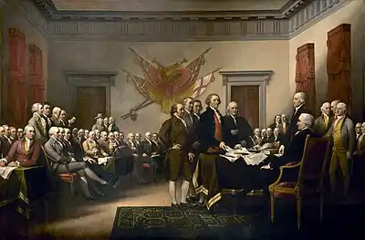 Declaración de Independencia de John Trumbull, 1817. Presentación al Congreso Continental por la comisión de los «cinco hombres» de la propuesta de Declaración de Independencia de los Estados Unidos (4 de julio de 1776). Aparecen entre otros Thomas Jefferson, Benjamin Franklin, John Adams y James Wilson. En este texto se aplicaron los valores de la Ilustración a la construcción del primer sistema político contemporáneo. La recepción de esta experiencia en Europa, principalmente en Francia, fue una mezcla de simpatía y paternalismo: el mito del buen salvaje contribuyó a ello, y también la habilidad diplomática del propio Franklin, embajador en París. Los estadounidenses se presentaron a sí mismos como resistentes a la tiranía, con referencias neoclásicas a la antigua República Romana, de la que se verán herederos de allí en adelante (Nueva Roma)