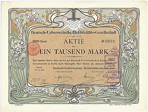 Acción de la Compañía Alemana Transatlántica de Electricidad por 1.000 marcos, emitida en Berlín en julio de 1906. El diseño gráfico de la acción es obra del artista modernista Otto Eckmann. El objetivo de la empresa, fundada por Deutsche Bank y AEG, era crear centrales eléctricas, principalmente en Sudamérica (Buenos Aires, Santiago de Chile, Valparaíso, Montevideo). Posteriormente, su actividad más importante fue, con diferencia, el suministro de electricidad a la capital argentina, Buenos Aires.