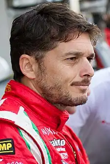 Giancarlo Fisichella wearing a red and white racing suit in 2012