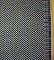 Ejemplo del patrón herringbone, una opción popular para trajes y prendas exteriores.