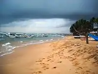 Playa de Hikkaduwa con la visión del coral y los barcos de pesca en el fondo