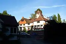 Very large white gabled house.