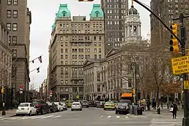 Temple Bar Building, a high-rise clad in brown brick, viewed in the background from an adjacent street