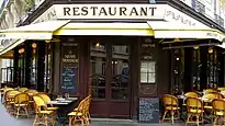 Paris street with a restaurant in the foreground