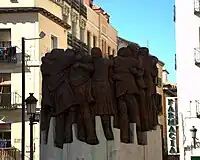 Monumento a los Abogados de Atocha (2003), basado en la obra pictórica El Abrazo, de Juan Genovés (1976), que había sido utilizada como cartel de la Junta Democrática en favor de la amnistía, a consecuencia de lo cual el autor fue detenido.