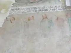 Fragmento de una banda de inscripción del siglo XIV que separa la franja de pinturas del lado norte del monasterio. A continuación se muestra una serie de reyes.