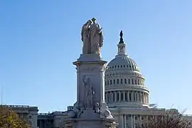 Dolor apoya su rostro cubierto contra el hombro de la Historia y llora de luto