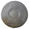 Anverso de moneda de 8 reales (plata) de Carlos IV de 1801 resellada en Cromford Mill, Gran Bretaña.