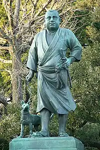 Estatua del samurai Saigo Takamori paseando a su perro.