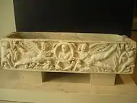 Sarcófago romano con niño portado por eros.