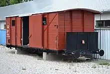 Photograph of a restored train car, with its sliding door open, used to transport Slovak Jews