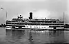 A large ferry, loaded with passengers