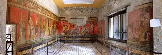 Ritual órfico-dionisíaco representado como un trampantojo sobre un entorno de arquitectura simulada en una estancia de la Villa de los Misterios en Pompeya.