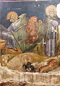 San Gerasimos el jordano sacando la espina de la pata del león con un cuchillo