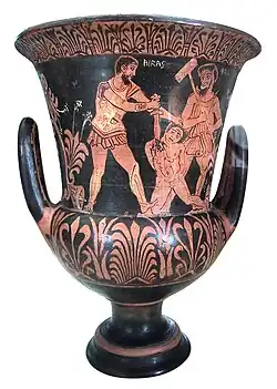 «Aquiles matando a un prisionero troyano en frente de Charun» (el demonio de la muerte etrusco, relacionado con el griego Caronte) armado con un martillo. Lado A de una crátera etrusca en forma de cáliz de figuras rojas, finales del siglo IV a. C., principios del siglo III a. C..