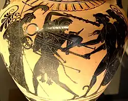 Ánfora de cerámica de figuras negras, que representa la disputa entre Apolo y Heracles por el trípode de Delfos. Relacionada con el denominado Grupo de Toronto 305. Hacia 510 a. C.[33]​