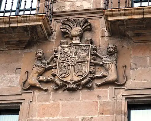 El Palacio de Ferrera se encuentra en la plaza mayor de la villa de Avilés (llamada de España o del Parche), y haciendo esquina con la calle de San Francisco. En sus dos fachadas ostenta sendas piedras armeras de igual composición: escudo sobre cartela de rollos cuartelado por una cruz flordelisada. En los cuarteles, las armas de Rodríguez de León, Avilés, Hevia y Estrada, y en escusón, las de Oviedo.[5]​ Ambos escudos están timbrados de yelmo empenachado, y solo se diferencian en que el de la fachada principal está sostenido por dos leones como soportes. Dichas armerías corresponden a los costados de Pedro de León y Menéndez de Avilés, que fue quien mandó construir el palacio a mediados del siglo XVII. Este señor (abuelo materno del primer marqués de Ferrera) fue en efecto hijo del capitán Pedro Alonso de León, regidor de Avilés y patrono del Hospital de San Juan, y de Mayor de Hevia, su mujer; nieto paterno de Simón de León de Quirós (descendiente de los Rodríguez de León pero con varonía González de Oviedo) y de María Alfonso de Arango, su segunda mujer, que era hermana uterina del adelantado Pedro Menéndez de Avilés. Y por línea materna, nieto de Diego de Hevia el Peco y de Sancha de Estrada, dueños de la casa de los Hevia de Villaviciosa y señores del coto de Poreño en el mismo concejo.[6]​