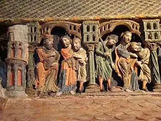 Vicente maniatado es llevado ante Daciano. En la segunda escena puede verse la huella de su pie que simboliza su fe cristiana.