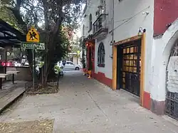 A sidewalk leading to the entrance of a café