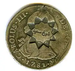 Anverso de moneda de 8 reales (plata) de Carlos III de 1781 resellada en Cheick Said.