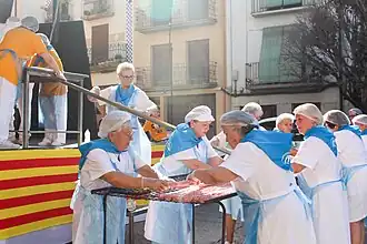 Mujeres de Santa Águeda preparando la parrilla de longaniza.