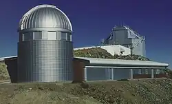 The enclosure of the Leonhard Euler Telescope with the higher situated New Technology Telescope (NTT) in the background