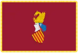 Estandarte oficial de la Generalidad Valenciana, que fija el escudo «sobre fondo carmesí tradicional ribeteado de oro»