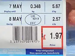 A food label, with a barcode, price tag, weight and dates for use by and display until