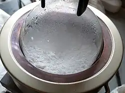 Water being extracted from the gypsum powder through heating.