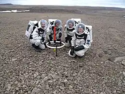 Crew members Brian Shiro, Christy Garvin, Stacy Cusack and Kristine Ferrone deploy the TEM47-PROTEM low frequency electromagnetic survey equipment on Haynes Ridge during EVA 8.