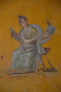 Fresco que representa a Urania, musa de la astronomía, con un globo terráqueo en la casa de Julia Felix, Pompeya.