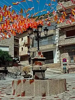 Fuente de piedra con cuatro chorros y un pilón. Encima cuenta con una farola en la que hay atadas muchas banderas de España y de Castilla y León. Estas banderas van desde la fuente hasta el final de la plaza en todas las direcciones, por lo que forman un abanico completo