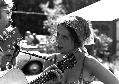Singer Maria Muldaur in 1968, wearing a gypsy-style kerchief and hoop earrings.