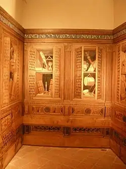 Studiolo de Guidobaldo de Montefeltro en Gubbio, 1479-1482. Atribuido a distintos artistas del taller del mismo Giuliano da Maiano, y en cuanto al diseño, a Francesco di Giorgio.[4]​