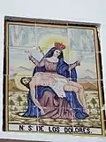 Panel cerámico de la Virgen de los Dolores en calle Virgen de las Angustias