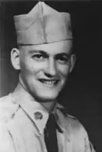 A head shot of a young soldier smiling towards the camera.