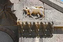 Altorrelieve de un toro a la derecha y por encima de la entrada