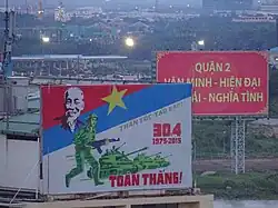 A large road sign in Ho Chi Minh City, Vietnam, commemorating the 30th April 1975. The pictures bears the declaration of a total victory.