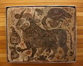 Socarrat del Museo de Bellas Artes de Castellón mostrando un toro, una garcilla bueyera y un tulipán.