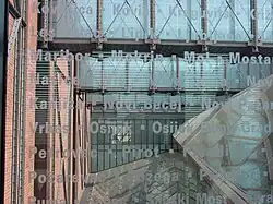 Puentes de vidrio en el USHMM. Vidrio azul grabado con nombres y lugares perdidos durante el Holocausto.