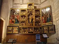 Retablo de San Juan Bautista de la iglesia del Salvador de Valladolid, ca. 1500 (el banco se realizó por artistas locales).[137]​